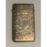 An Edwardian silver card case, engraved and chased with foliate scrolls, 8cm high, Birmingham 1907