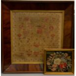 A large 19th century sampler, embroidered by Ann Wilson, 1882, with verse, flowers and