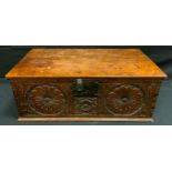 A late 17th century oak bible box, c.1680 carved with floral roundels, the interior with candle box,