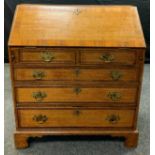 A George III oak bureau, inlaid with chequered band, the fall front with fitted interior, above