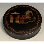 A 19th century japanned papier mache waisted circular table snuff box, the cover decorated in the