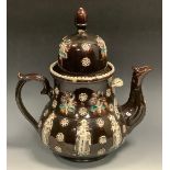 A Victorian bargeware teapot, inscribed M and A Jackson, applied with oriental figures, flower