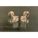 A pair of round brilliant cut diamond stud earrings, each approx 0.50ct, total estimated diamond