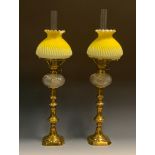 A pair of 19th century ejector candlesticks, reel shaped sconces, canted base, now with clear