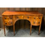 A George III mahogany and satinwood strung sideboard, c.1790 with gallery back, shaped front with