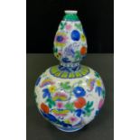 A Chinese double gourd vase, painted in he Doucai palette with butterflies amongst flowers, 21.5cm