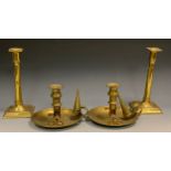 A pair of brass chambersticks, conical snuffers, wick trimmers, 16cm diam, late 19th century; a pair