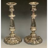 A pair of George/William IV Old Sheffield Plate table candlesticks, campana sconces with