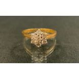 A diamond floral cluster ring, inset with seven round brilliant cut diamonds, total estimated