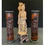 A pair of Chinese bamboo incense burners, carved with figures, mountains and pine trees, 28.5cm