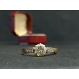 A diamond solitaire ring, old brilliant cut diamond approx 0.50ct, above diamond accented shoulders,