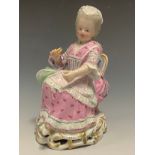 A Meissen figure, of a lady, c.1880 seated, a shuttle in her left hand, wearing a lace dress,