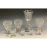 A Freemason clear glass goblet, the bell shaped bowl engraved with shaking hands and heart within