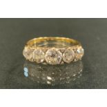 An Edwardian old cut diamond ring, linear set with five graduated diamonds, total estimated