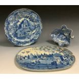 An English Pottery pierced oval drainer, printed in blue wit mosque and shrine, 34cm wide, c.180;