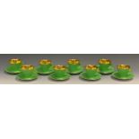 A set of eight Shelley Pottery Vogue coffee cups and saucers, gold interior, lime green exterior,