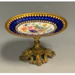 A Victorian ormolu mounted miniature comport, enamelled with colourful summer flowers, within banded