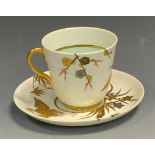 A Royal Worcester Aesthetic Movement cabinet cup and saucer, decorated in gilt and silver with