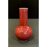 A Chinese sang de beouf bottle vase, glazed in red, 14.5cm highm seal mark