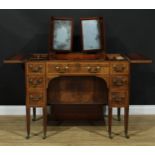 A George III mahogany dressing table, rectangular top enclosing a pair of adjustable mirrors and