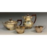 A silver four piece panelled boat shaped tea service, gadrooned border, hotwater jug 20cm high,