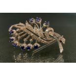 An 18ct white gold diamond and sapphire leaf shaped floral spray brooch, unmarked, 6.6g, 4.5cm,
