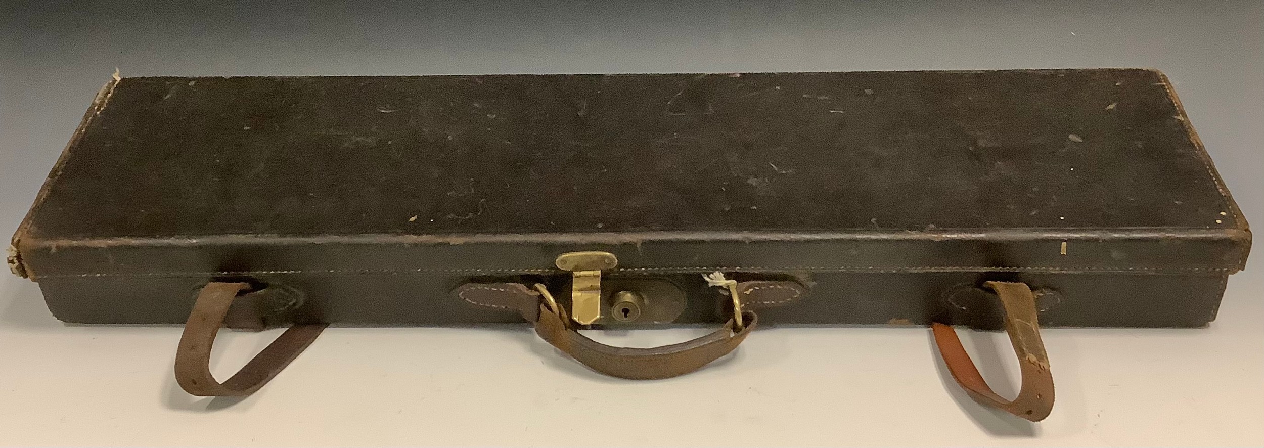 An early 20th century leather rectangular gun case, 82.5cm wide