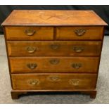 A George III oak and mahogany crossbanded chest, of two short and three long drawers, the top inlaid