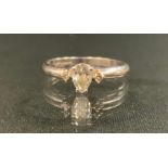 A diamond ring, central pear cut diamond approx 0.30ct, colour F/G, clarity VS1/VS2, between smaller