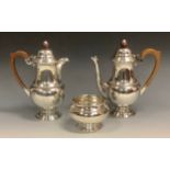 A silver three piece coffee set, comprising coffee pot, hot water jug, and sucrier, beaded