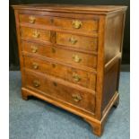 A 19th century oak chest, c.1800 of one long, two short and three long graduated drawers, bracket