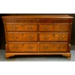 An 18th century oak chest, c.1790 hinged top above two blind, two short and one long drawer, bracket