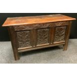 A George II oak blanket box, the front carved with stylised leaves, 73cm high, 128cm wide, 57cm