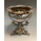 An E.P.B.M. table centrepiece, the bowl, embossed with flowers and foliage, triform stand, 19cm