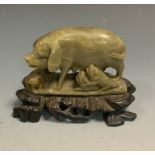 A 19th century Chinese soapstone model, of a pig with piglets, hardwood base, 9cm high, 12cm wide