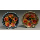 A Moorcroft Pomegranate pattern shallow circular bowl, tube lined with large fruit and berries, on a