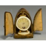 An early 20th century French gilt metal 'Heart Beat' travel clock, Arabic numerals, radiating yellow