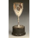 A Victorian pedestal goblet, embossed with oval cartouches and scrolls, knopped stem, spreading