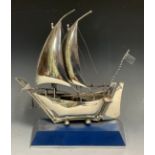 A silver model of a sailing boat, with two sails, 23cm wide, marked silver 925, 8.4ozt