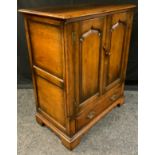 A Titchmarsh and Goodwin oak side cabinet, two doors above base drawer, 99cm high, 88cm wide, 47.5cm