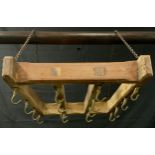 A pine and brass suspension kitchen hanger, with sixteen brass pan hooks, 60cm long, 40cm wide