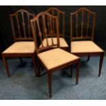A set of four mahogany Hepplewhite dining chairs, drop in seats