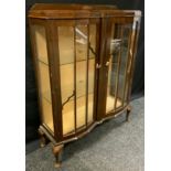 A 1940's mahogany china display cabinet, canted, break-front centre, glazed doors and sides,