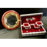 A brass ships porthole mirror, 35cm diameter; a jewellery box, as a book embossed with Elephants and