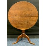 A 19th century oak tilt-top pedestal table, circular top, turned column, 67cm tall x 77cm