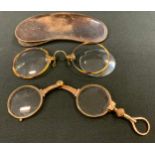 A pair of late Victorian rolled gold pince nez, slide spring action, leather case; faux