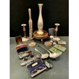 A pair of Sheffield plated telescopic candlesticks; an Onslow ladle; a pair of bottle coaster; etc