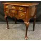 A George III style mahogany lowboy, over sailing top above one long and three short frieze