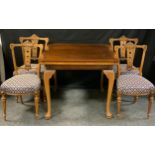 A walnut draw leaf dining table and set of four turn of the century walnut dining chairs, c.1900-