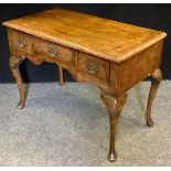 A George III style walnut lowboy, three frieze drawers, shaped frieze, cabriole legs, pad feet, 70cm